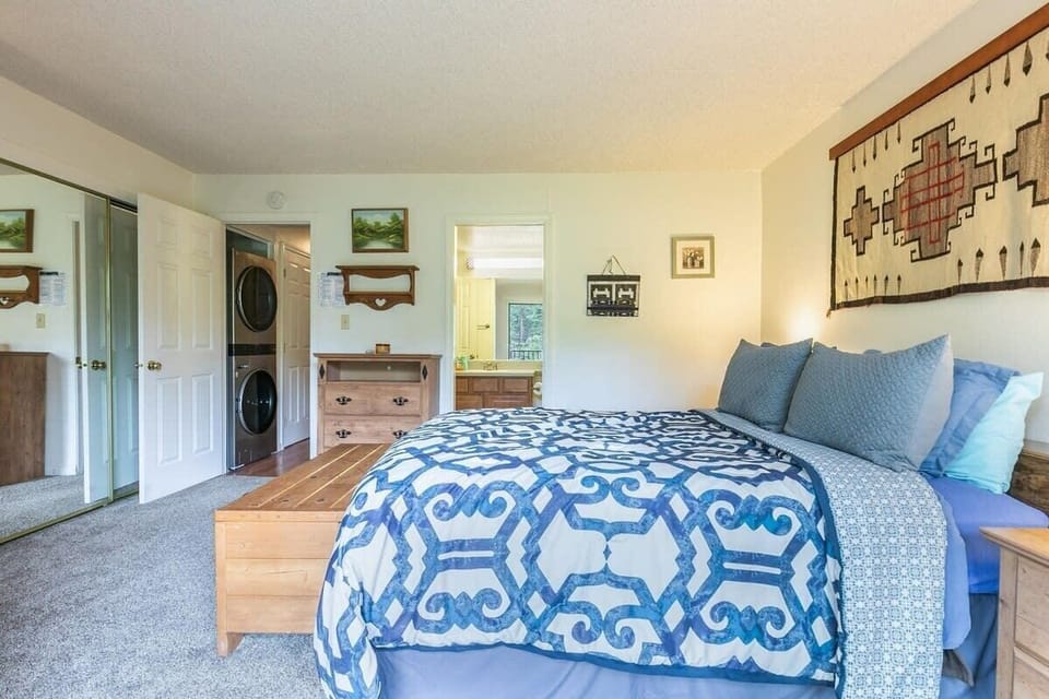 The spacious master bedroom has everything you need for a comfortable stay from a queen-size bed to a private balcony and en suite bathroom.