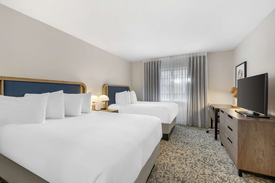 Stretch out comfortably with two cozy beds and warm lighting.