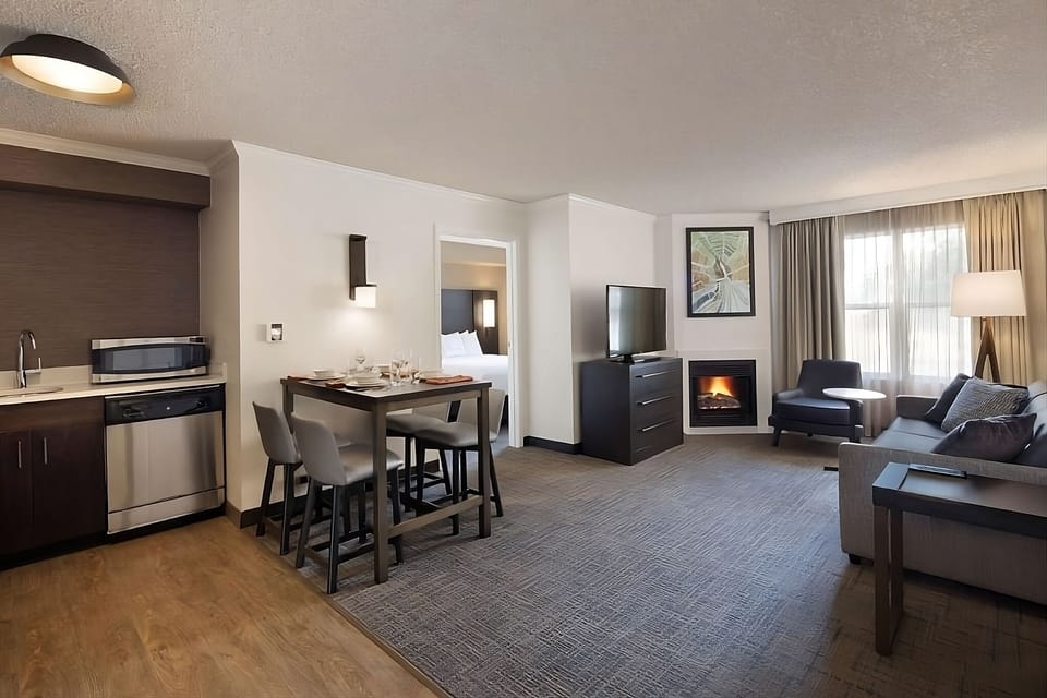 Unwind by the fireplace in a bright, spacious living area.