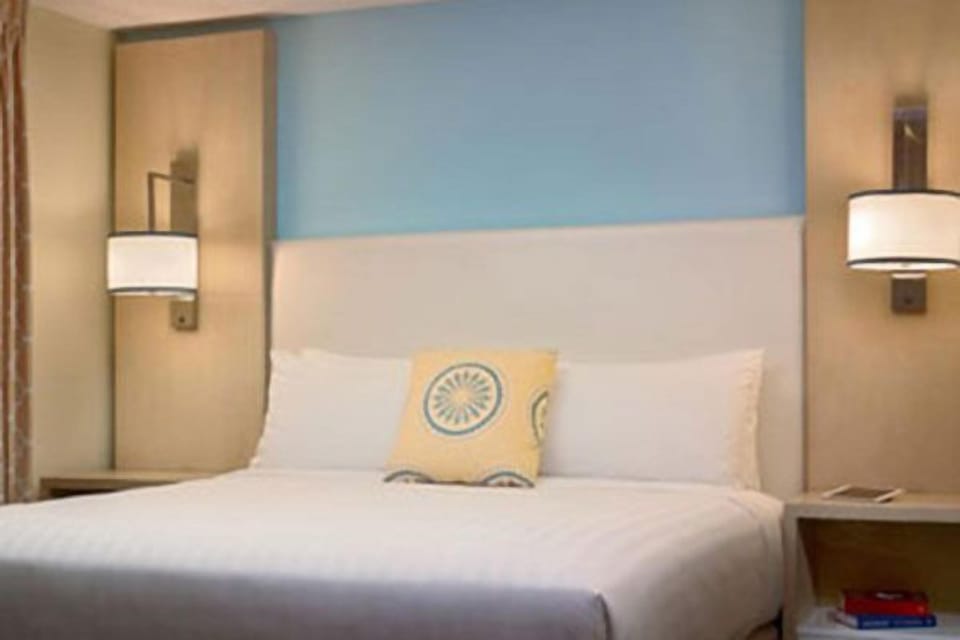 Drift off comfortably in a serene room with warm bedside glow.