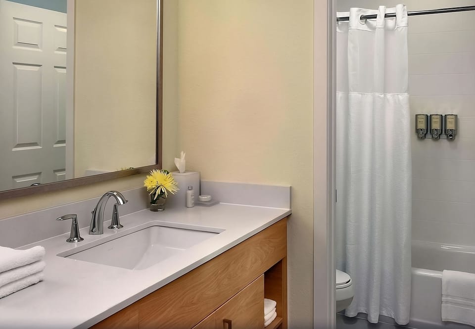 Refresh with a spotless vanity and relaxing shower-tub combo.