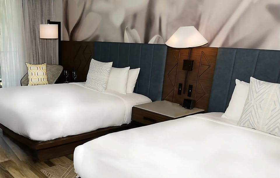 Relax under soft lighting and a stylish upholstered headboard.