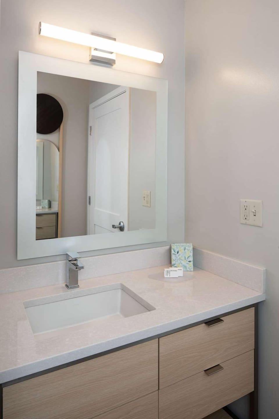 Refresh at a sleek vanity with bright, flattering mirror light