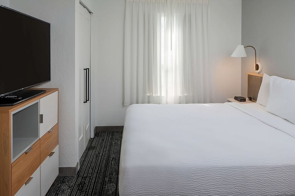 Settle into crisp linens with TV and soft evening lighting