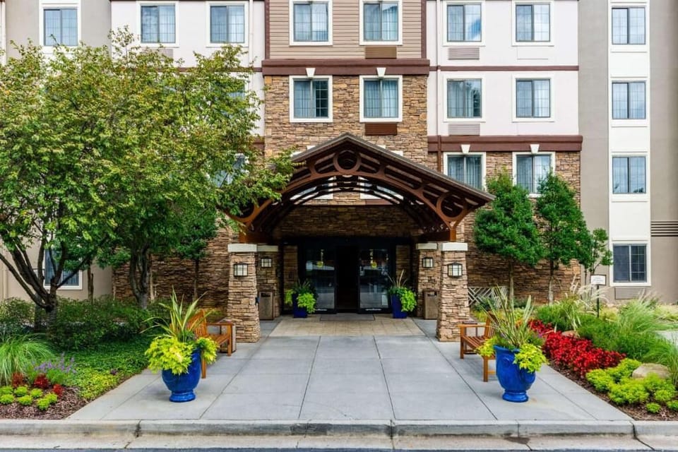 Step up to the bright lobby entrance framed by lush landscaping.