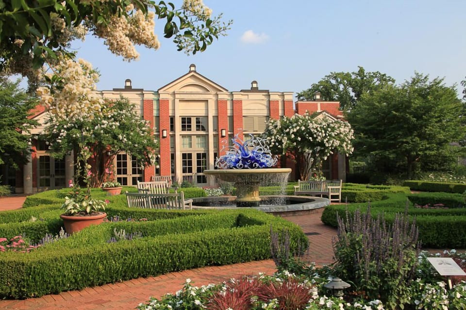 Stroll through manicured gardens beside a sparkling courtyard fountain.