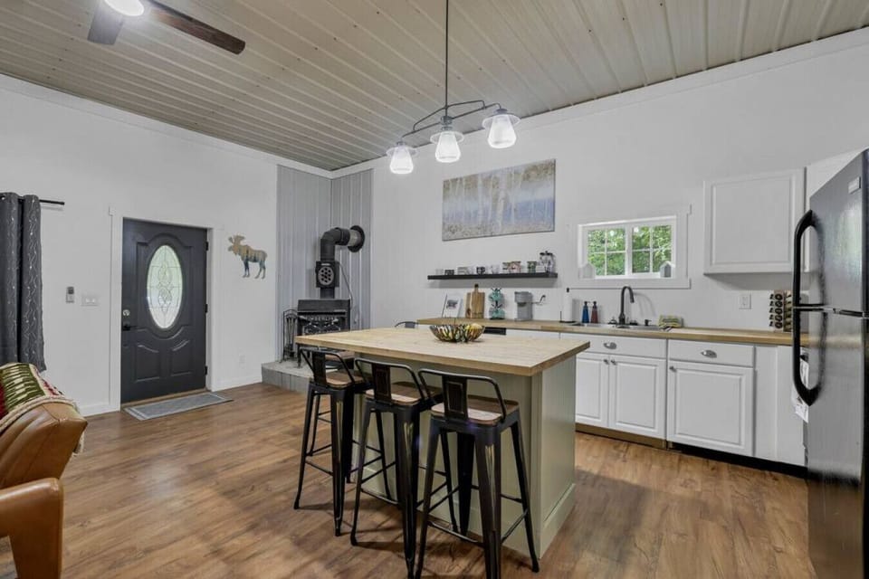Kitchen and island with bar stools