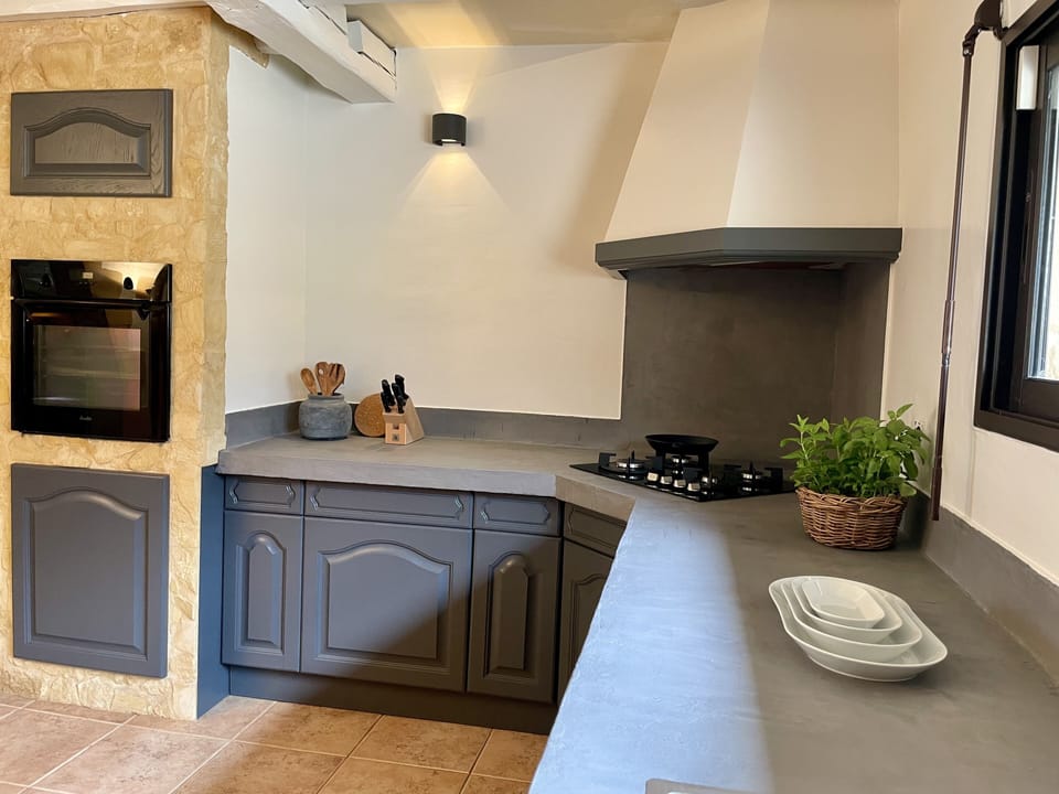 Fully equipped kitchen with modern appliances and rustic charm
