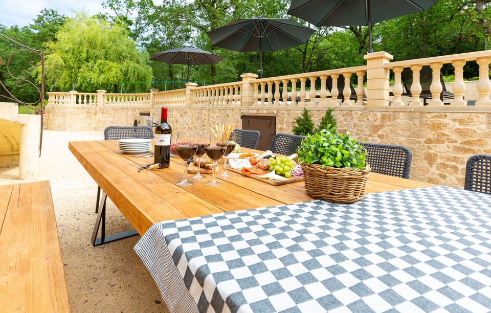 Outdoor dining terrace overlooking the pool — perfect for long summer evenings