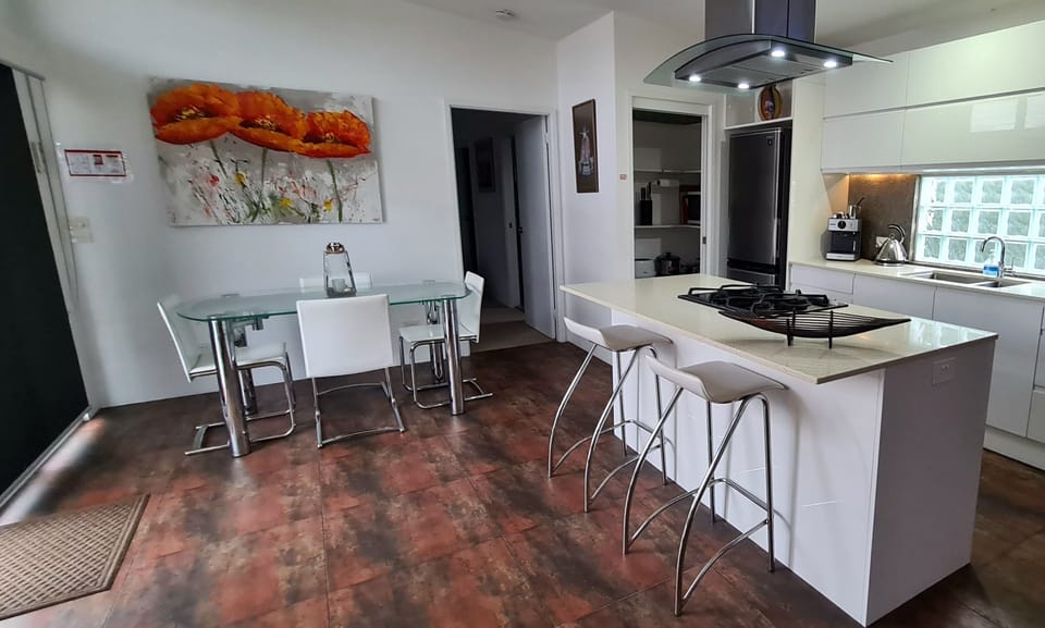 Kitchen with gas cook top electric oven, dish washer & coffee machine.