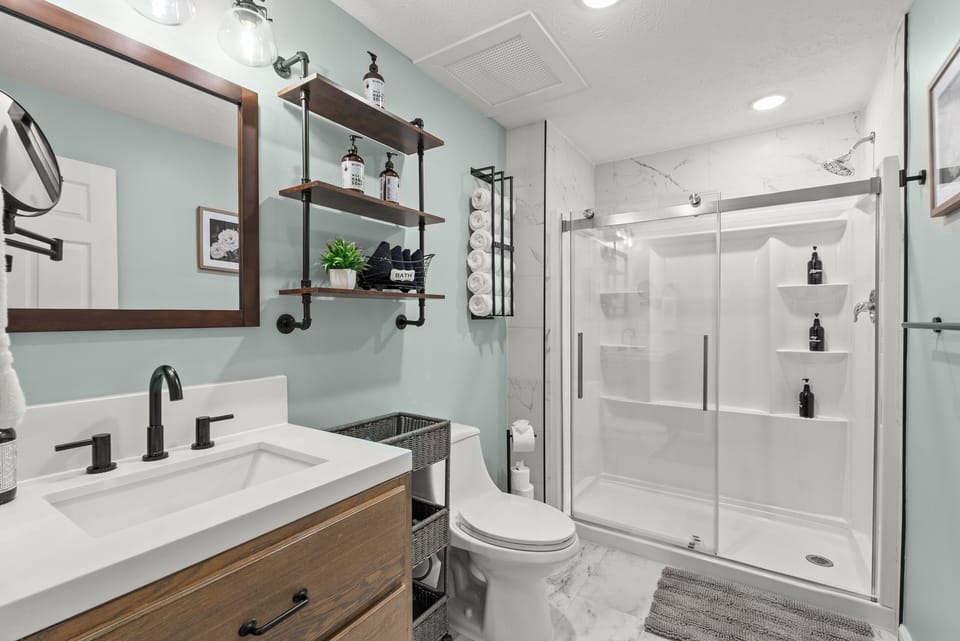Main level primary ensuite: bathroom attached to main level king bedroom.
