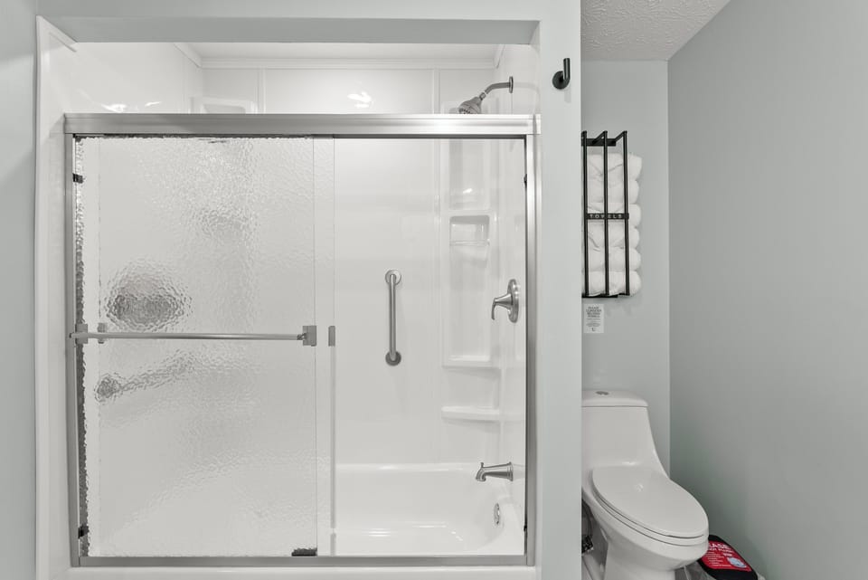 Shower / tub combo main level hall bathroom that services the "Boho" and "Blush"queen sized bedrooms