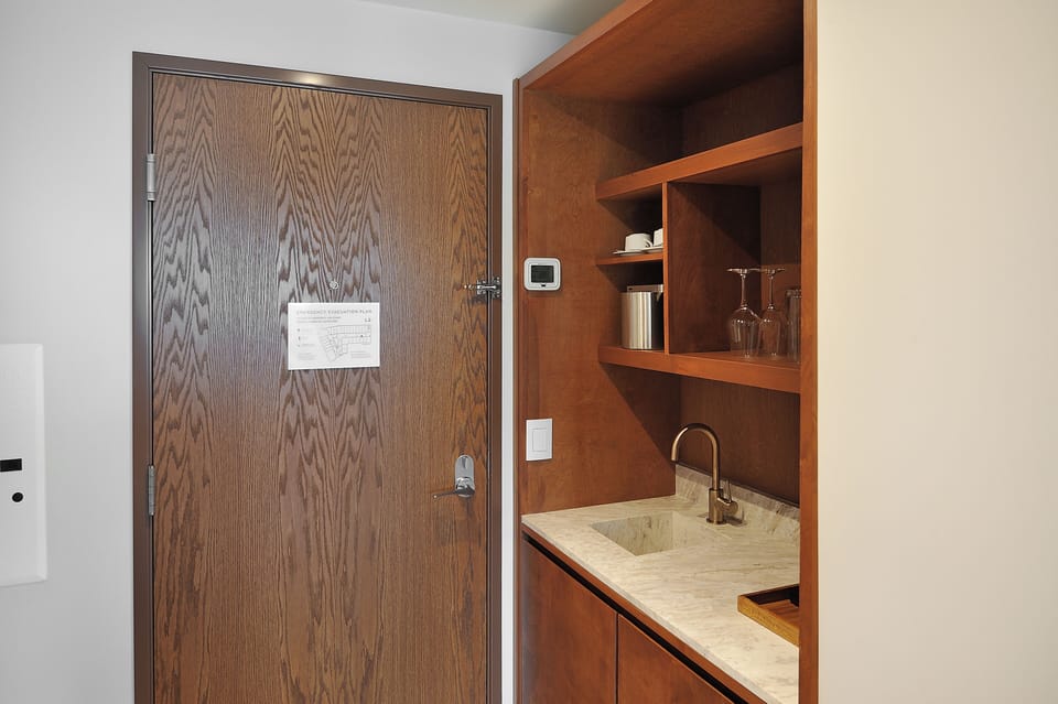 Prep easy snacks in the sleek kitchenette with bar sink.