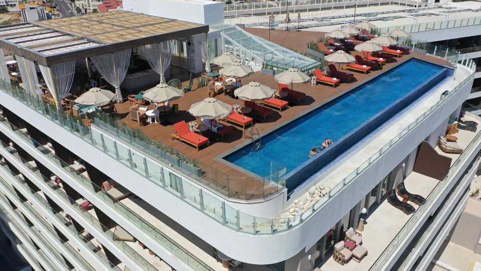 Dive into rooftop luxury with cabanas, loungers, and skyline views