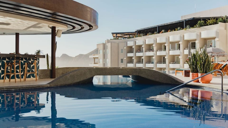 Sip poolside cocktails at the stylish swim-up bar oasis