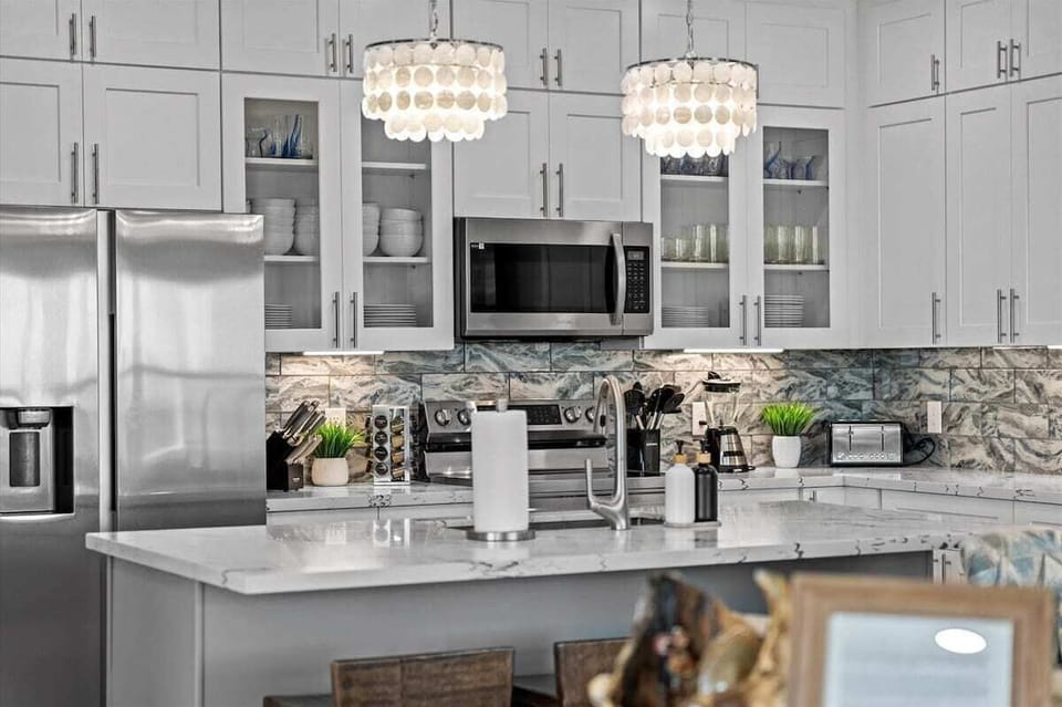 Modern chef's kitchen with elegant lighting, high-end appliances, and spacious layout perfect for cooking and entertaining.