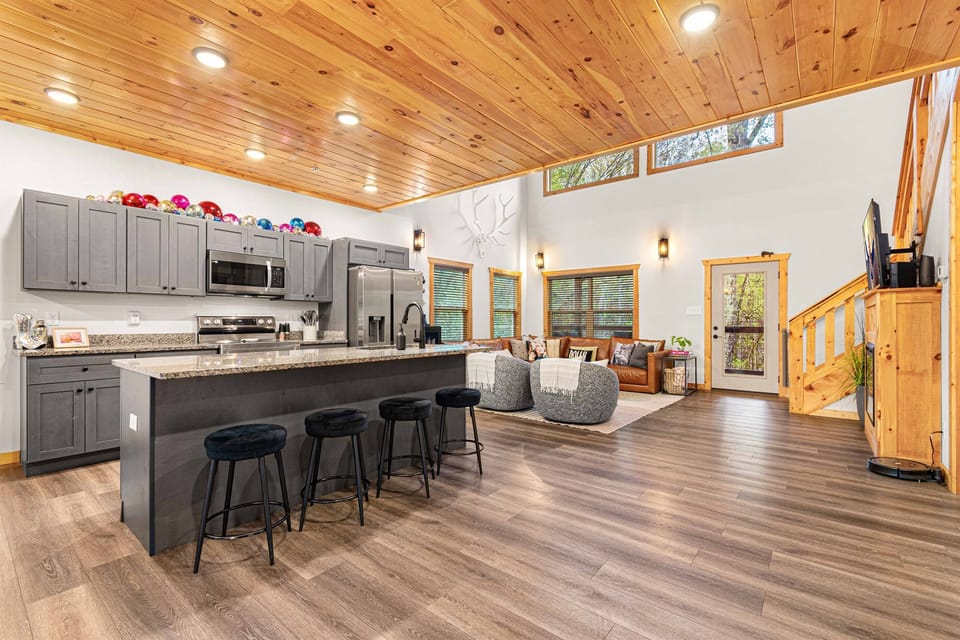 View of kitchen from walking in the main door. Extra seating at bar.