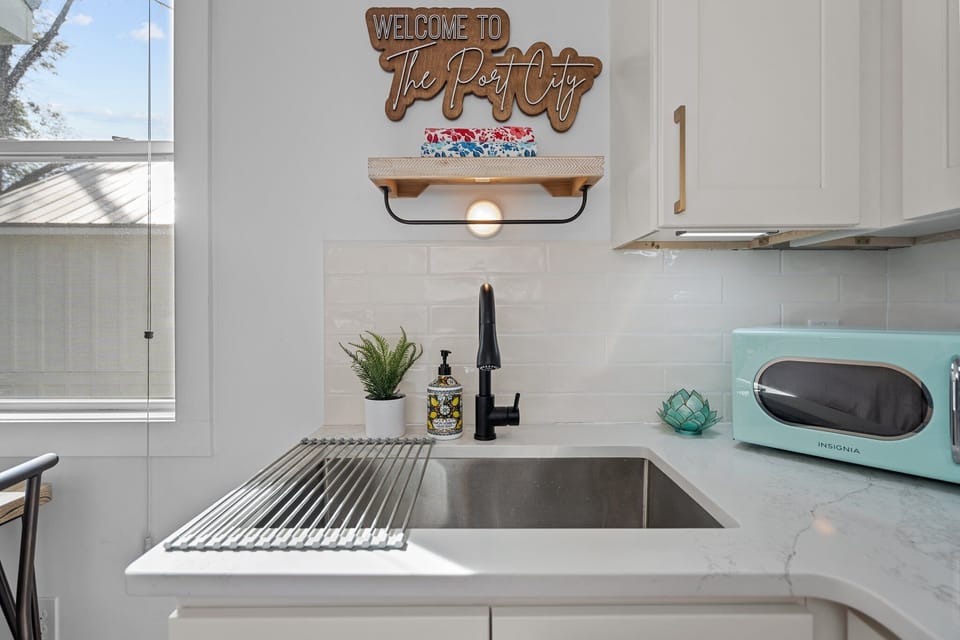 Kitchen cupboards include silverware, dishes, sugar, creamer and to-go cups
