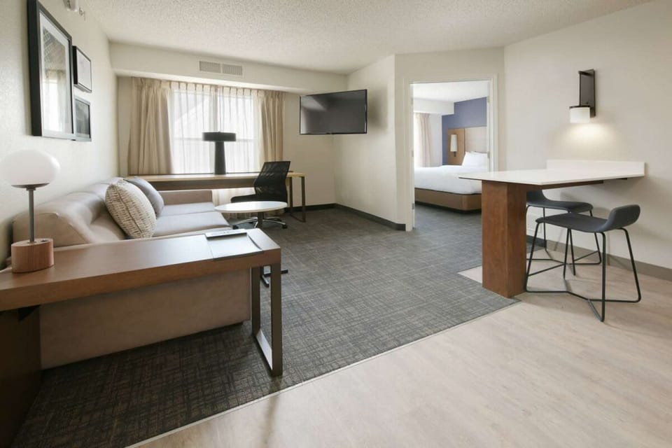 Settle in with a cozy sofa, desk, and open layout.