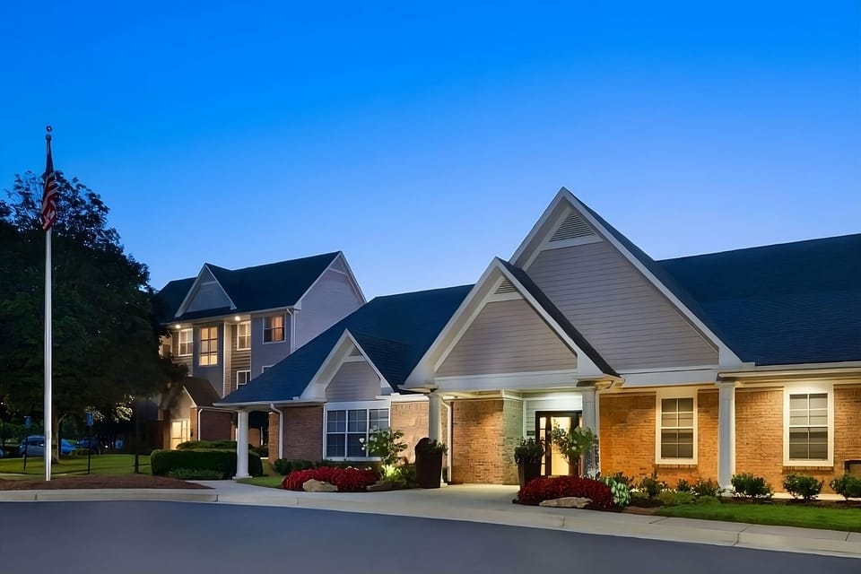 Come home at dusk to warm lights and landscaped grounds.