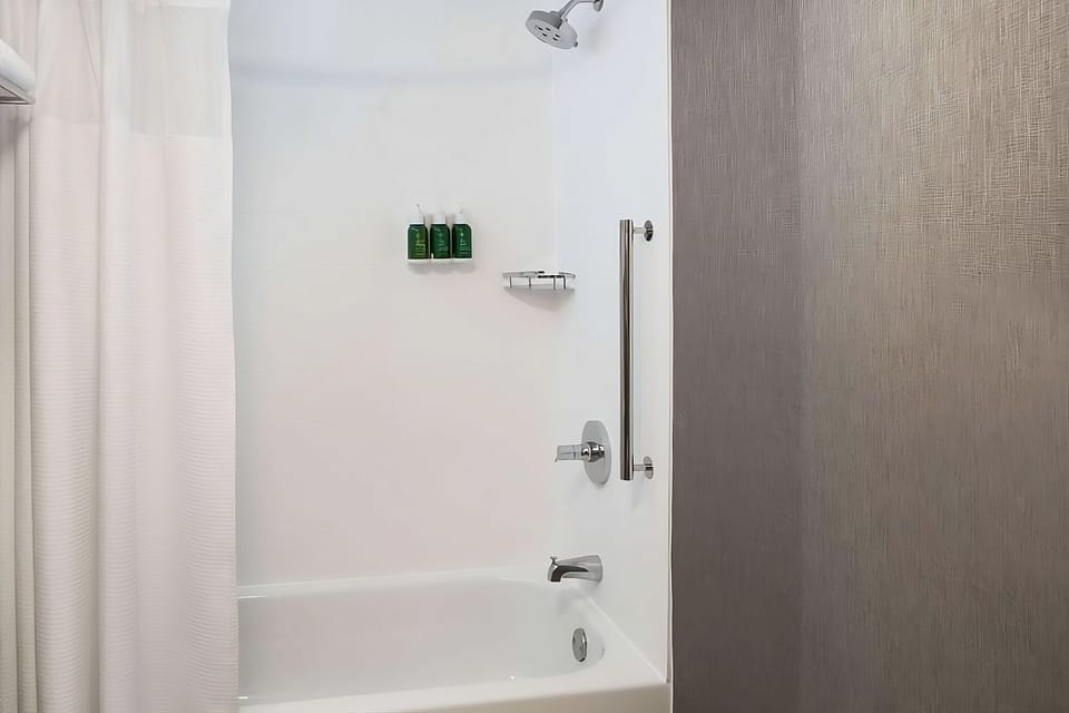 Refresh with a hot shower in a spotless tub setup.