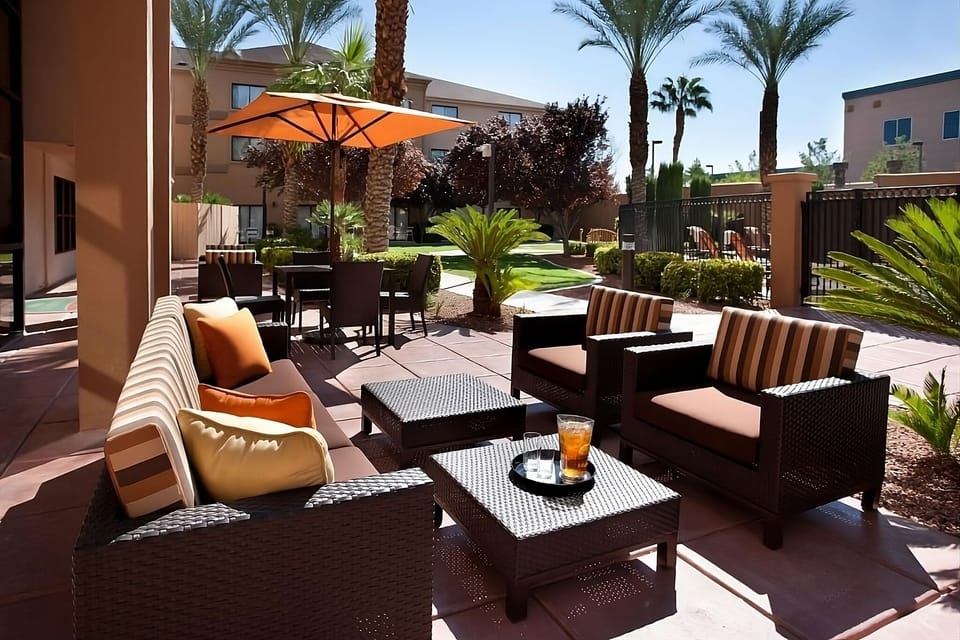 Sip something cool on the shaded patio among palms.