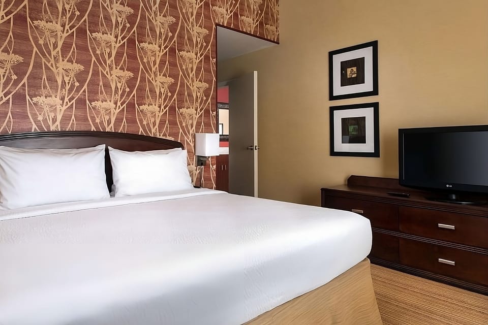 Drift off comfortably in a quiet king room with warm lighting.