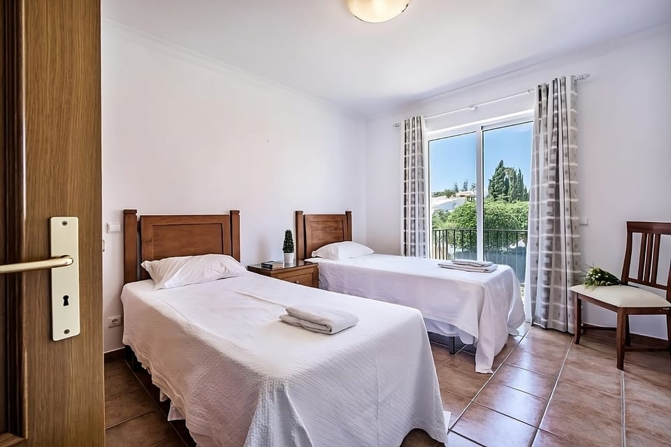 Drift off peacefully in twin beds beside a sunny window.