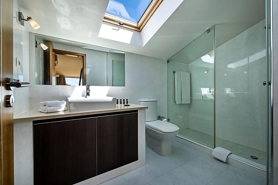 Start the day in a bright, glass-shower bathroom retreat.