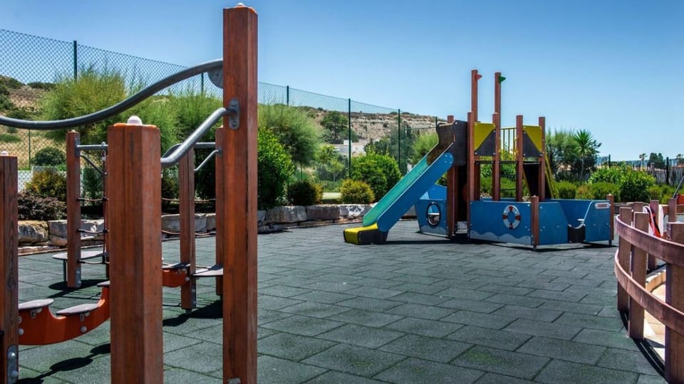 Let kids climb and slide safely under bright skies.