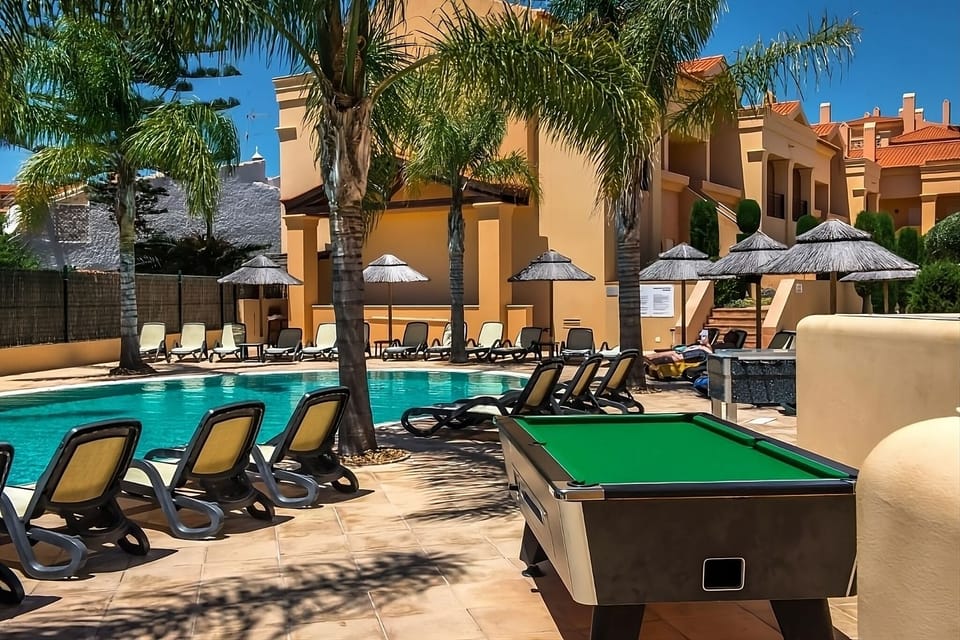 Soak up the tropical feel beside the sparkling palm-lined pool.