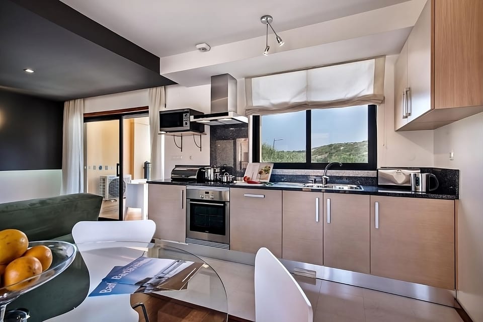 Cook with ease in the sleek kitchen beside sunlit doors.