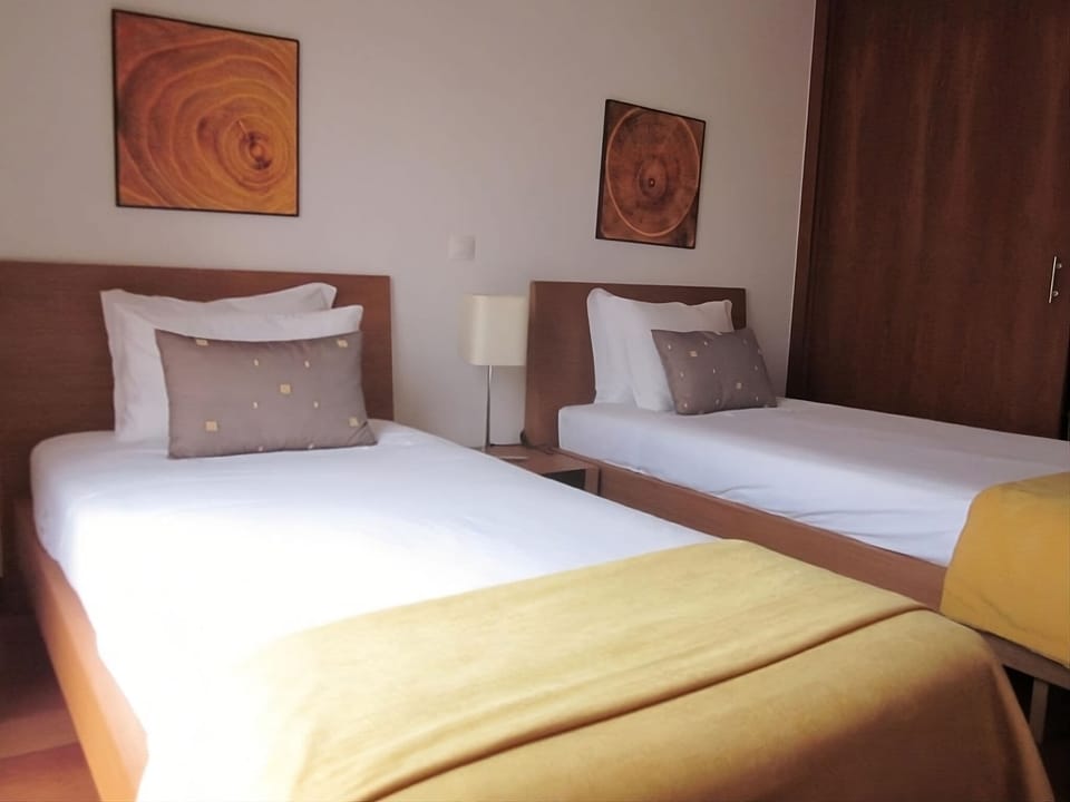 Recharge together in twin beds dressed in crisp, clean linens.