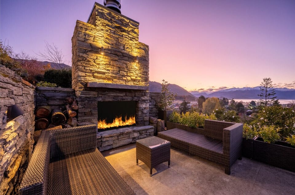Outdoor fireplace with mountain I lake views