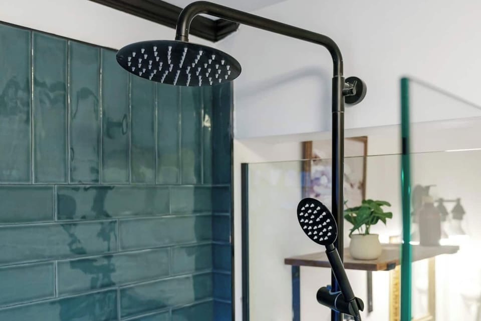 A tall and spacious rain shower is waiting at Berger Haus. 
