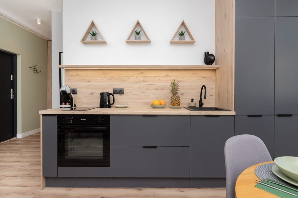 A wider perspective of the kitchen, highlighting its contemporary design and practicality.
