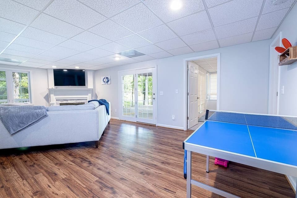 The downstairs living area complete with gas fireplace, large screen tv and ping pong table. 