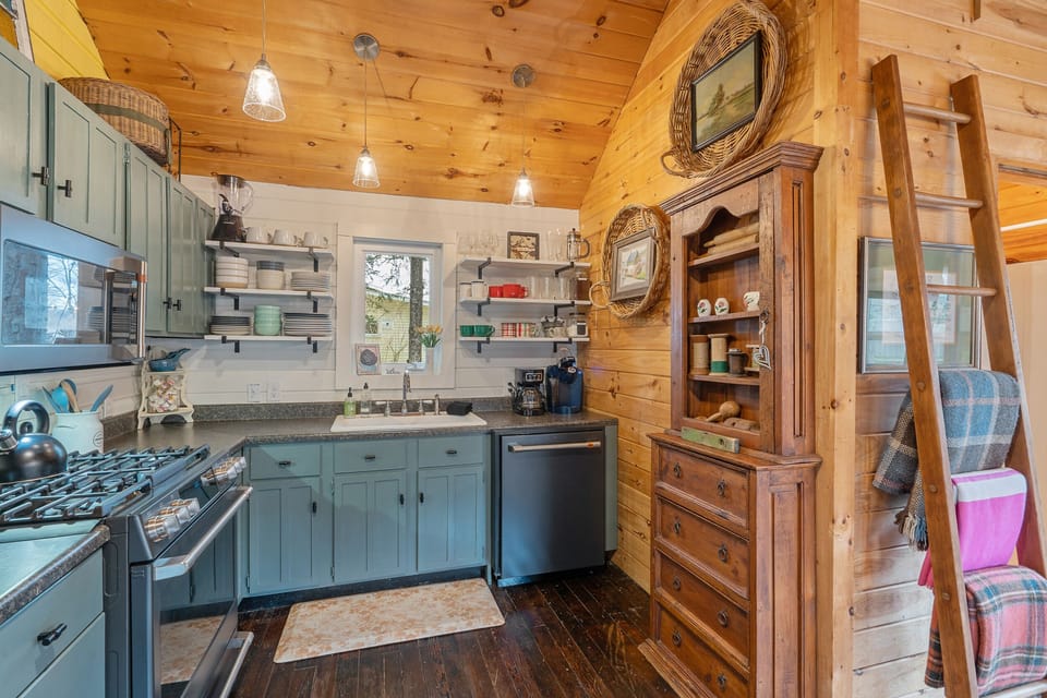 Vintage cabinet stores tea & coffee. The ladder holds blankets for outdoor fire.
