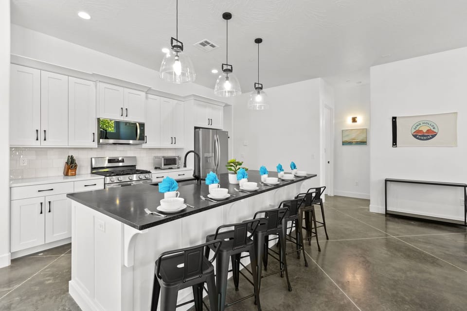 This stylish kitchen has a dishwasher, large fridge, gas range, microwave, toaster oven, KitchenAid mixer, hand mixer, griddle, Instant Pot, crock pot, and two coffee makers—fully equipped for easy meal prep during your stay.