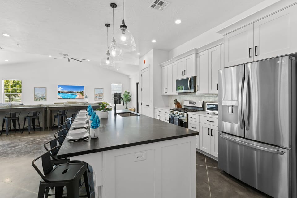 Enjoy cooking with a view of the TV and main living area, plenty of space for multiple people to prep together, and a large counter perfect for serving meals.