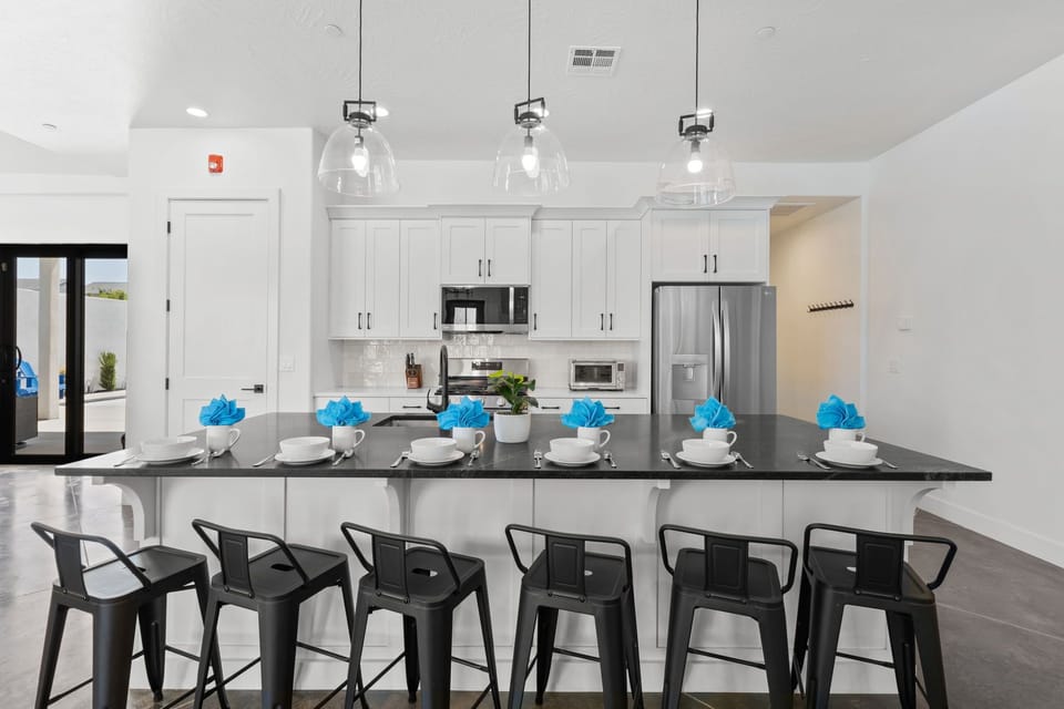 The pantry closet stores small appliances and provides shelf space for vacation food, while the 10-ft island with six bar stools is perfect for gathering.