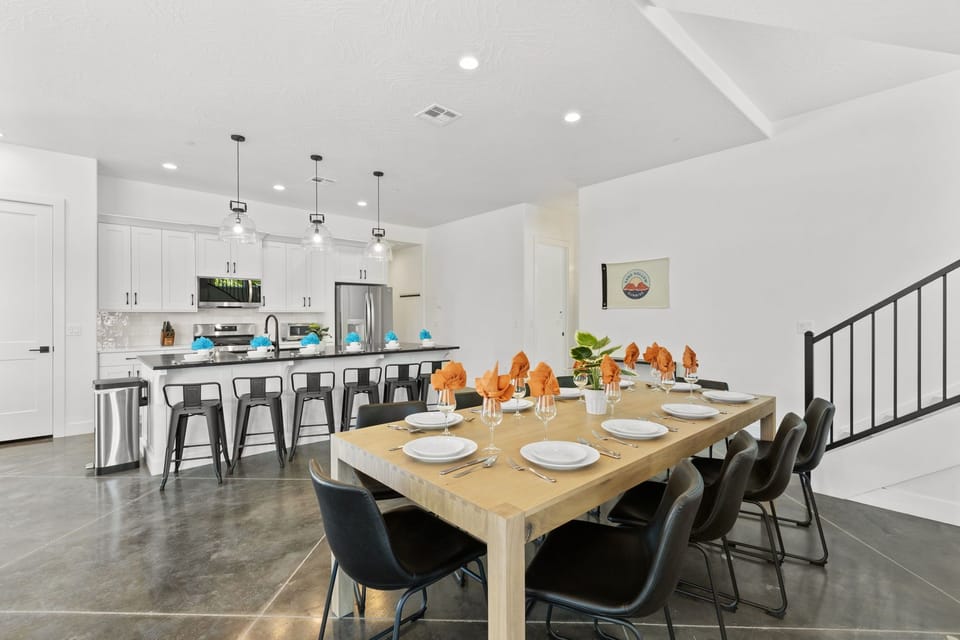 This modern, well-stocked kitchen features sleek finishes, ample counter space, and a spacious dining table—perfect for gathering and easily preparing any meal during your vacation.