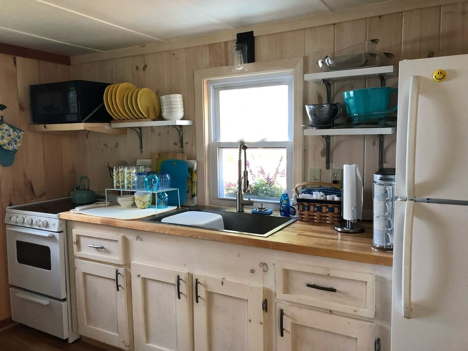 Updated kitchen with full refrigerator, oven, microwave and Keurig.