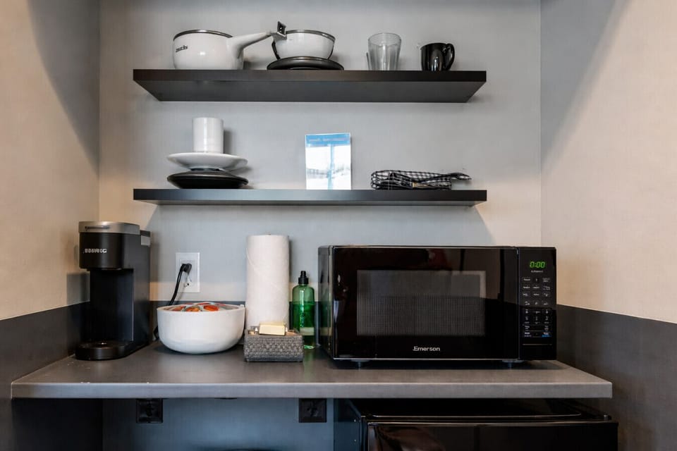 Well equipped kitchenette featuring a microwave, coffee station, and practical counter space.