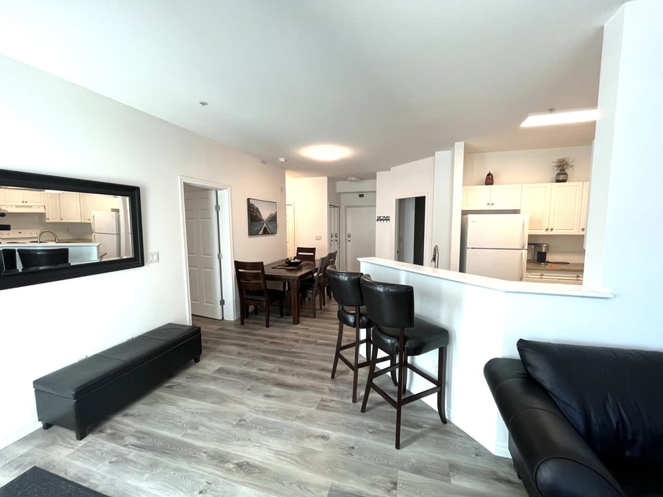 The dining room area has a nice wooden table that seats four.