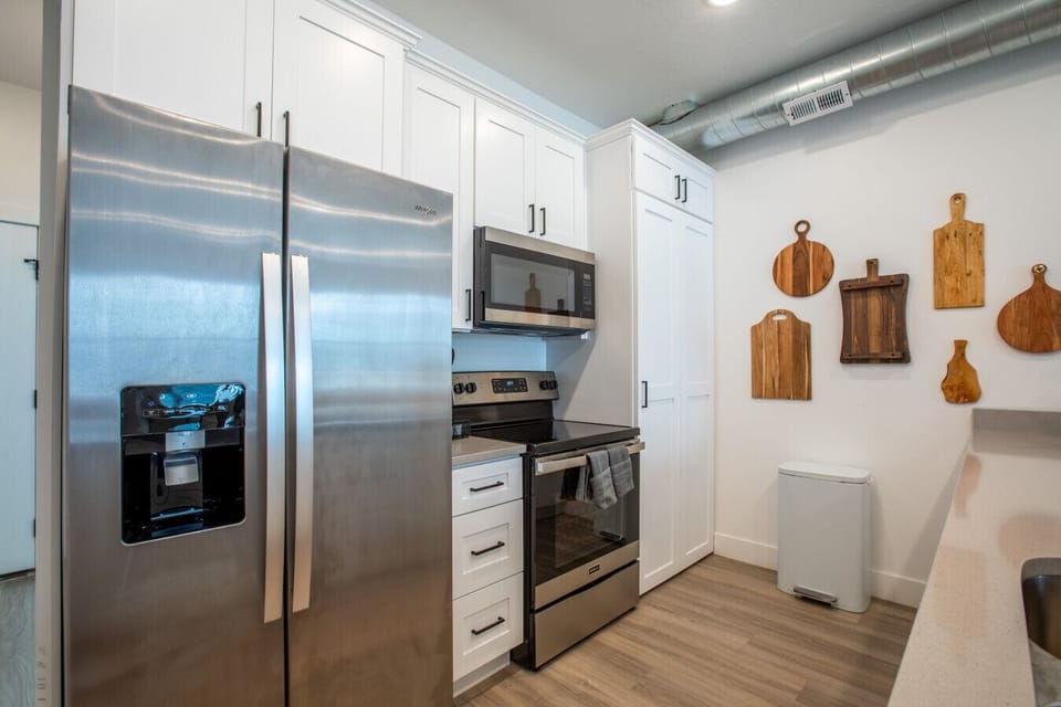 Fully stocked kitchen with stainless steel appliances and walk-in pantry.
