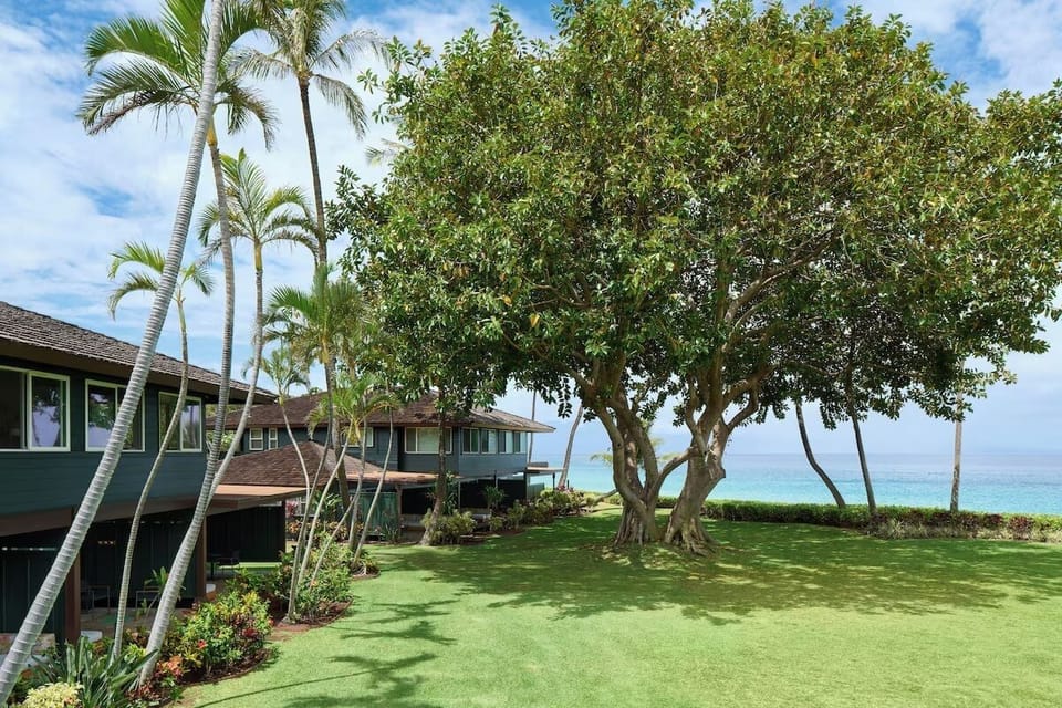 Stroll through lush lawns to the sparkling beachfront beyond.
