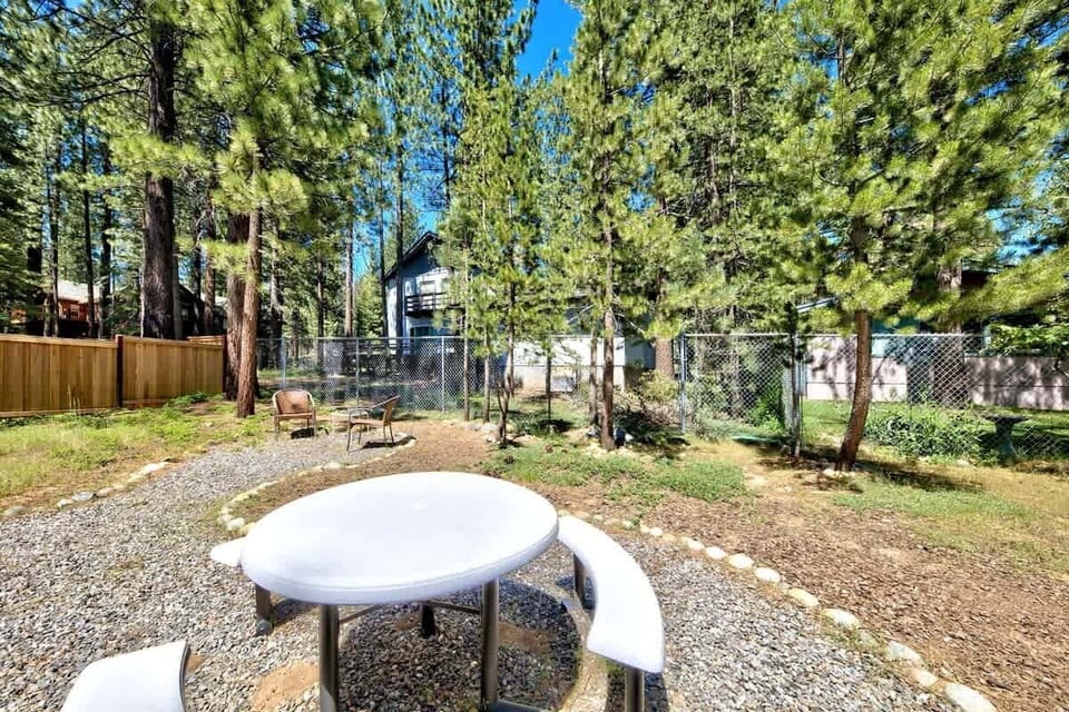 The fully fenced private backyard gives everyone room to enjoy the outdoors, with space to relax beneath the surrounding Tahoe pines.