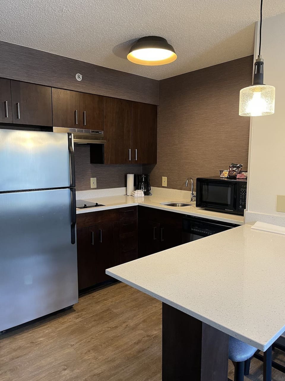 Cook and snack easily in your full kitchen with bar seating.