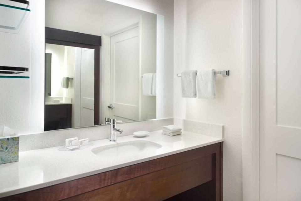 Refresh effortlessly at a spotless vanity with plush towels.